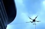 Autonomous facade cleaning drone on skyscraper