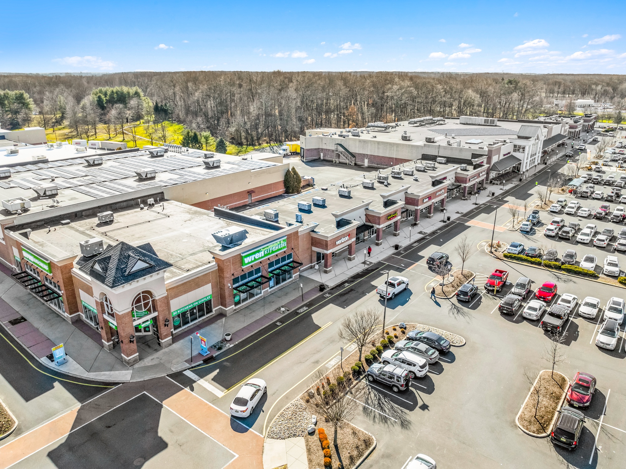 Aerial view of a multi-building retail complex with pedestrian walkways and mixed-use tenant layout