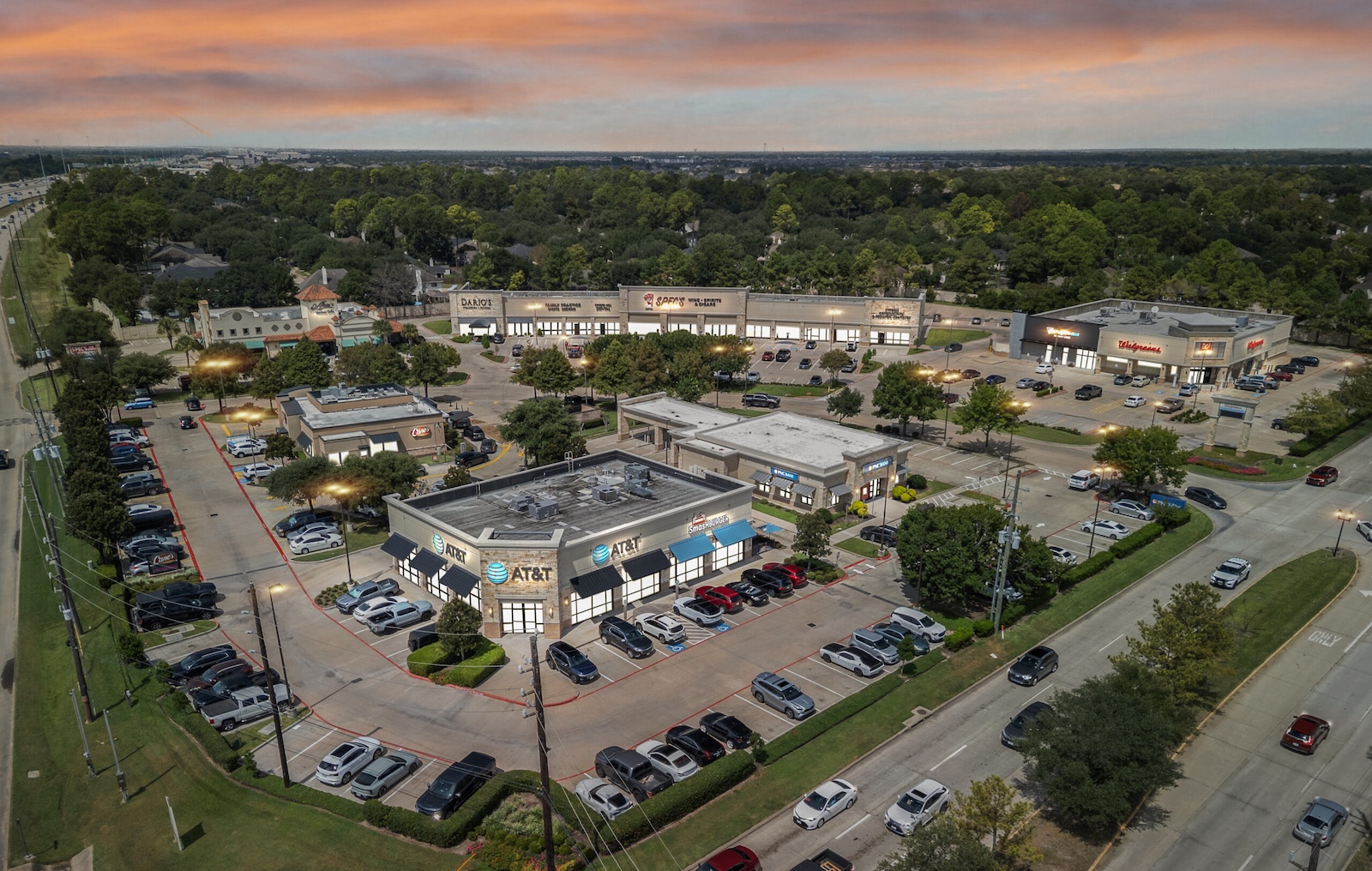 Virtual Twilight photo of industrial property at dusk with illuminated buildings and vibrant sky