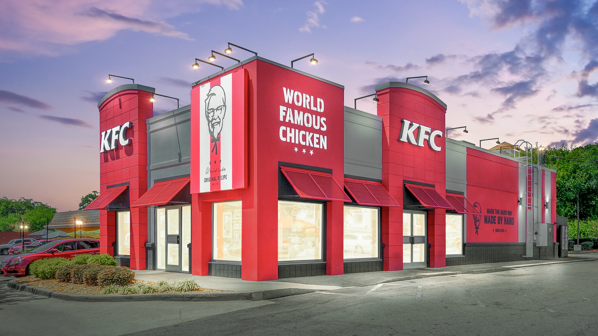 Virtual twilight photograph of a single-tenant QSR restaurant with illuminated signage and vibrant dusk sky