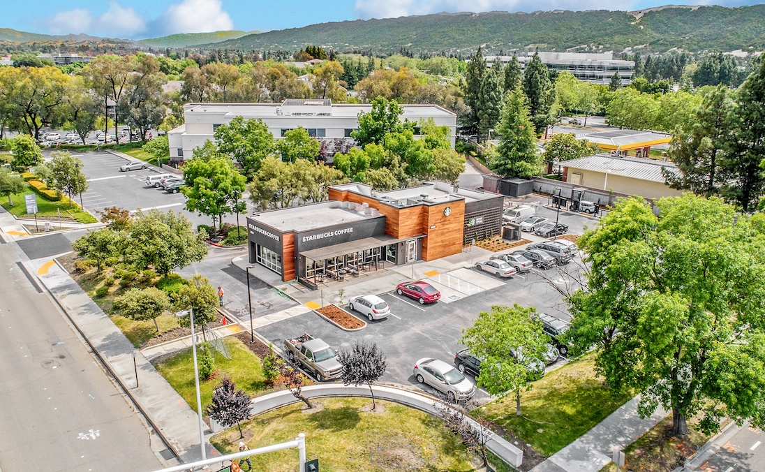 Aerial photography of a Starbucks commercial property showing building, parking, and surrounding context
