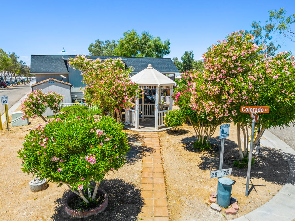 Aerial photography of mobile home community gazebo with flowering landscaping and walkway