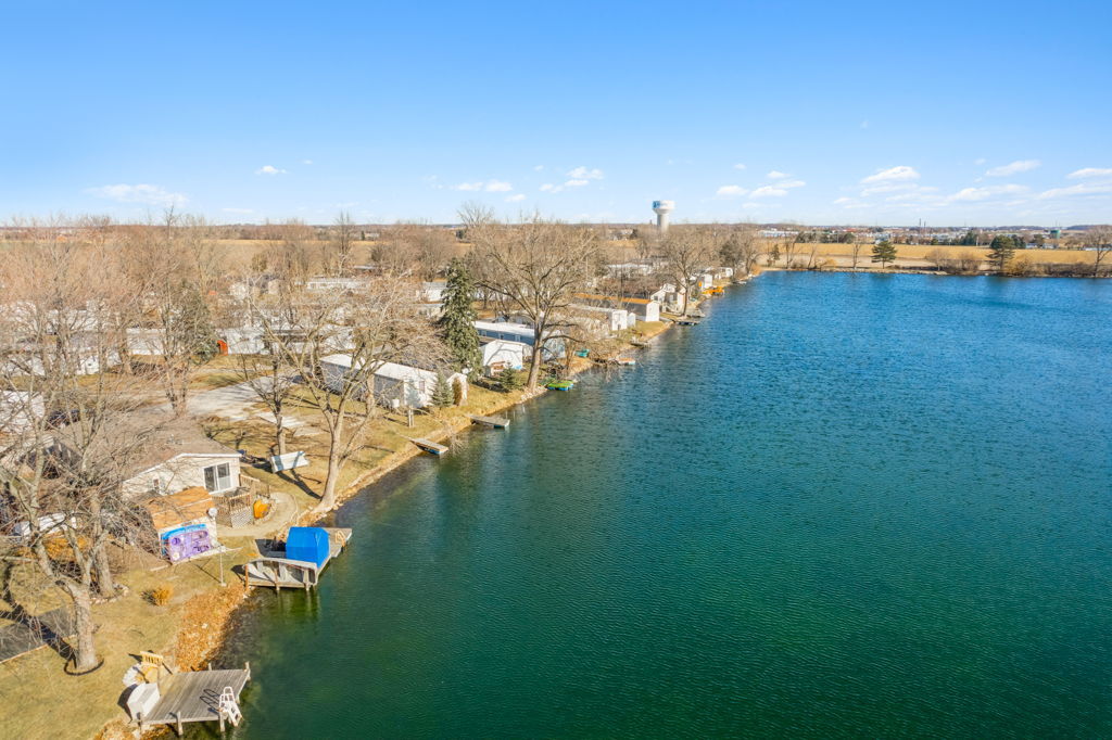 Aerial drone photography of lakefront mobile home community with waterfront lots and boat docks