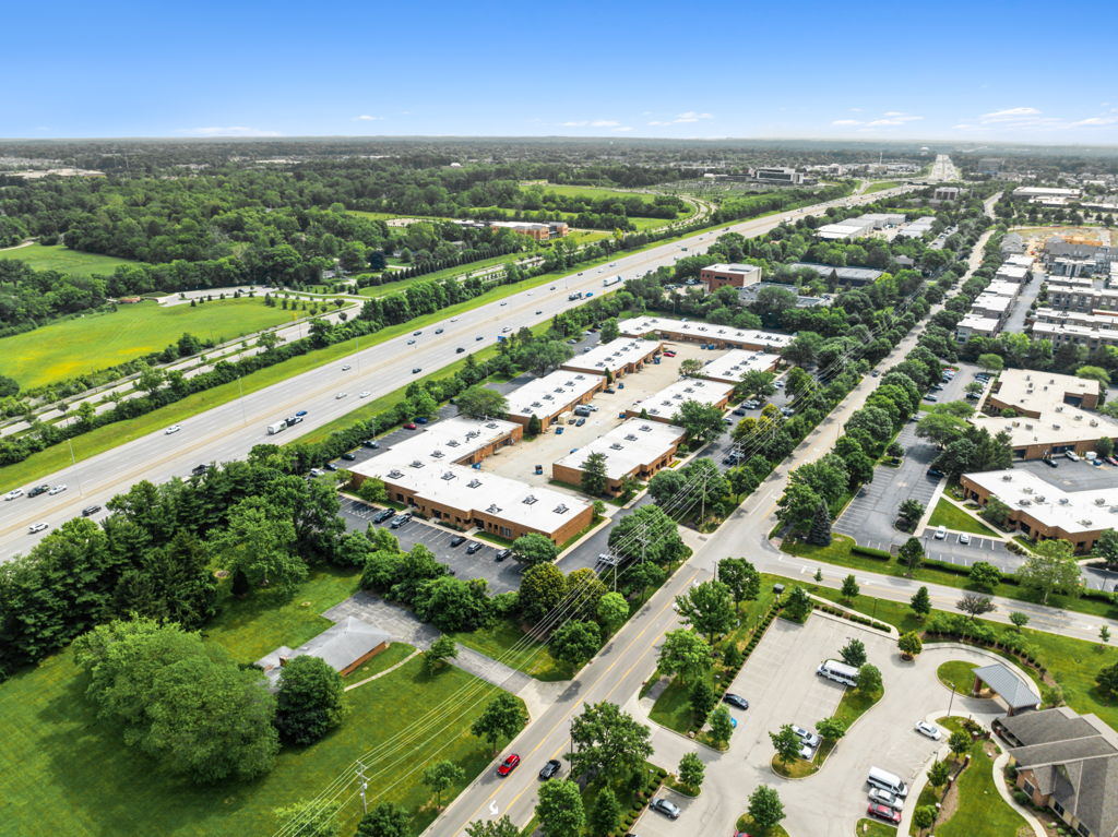 Aerial drone photography of multi-tenant power center with big-box retail and large parking field
