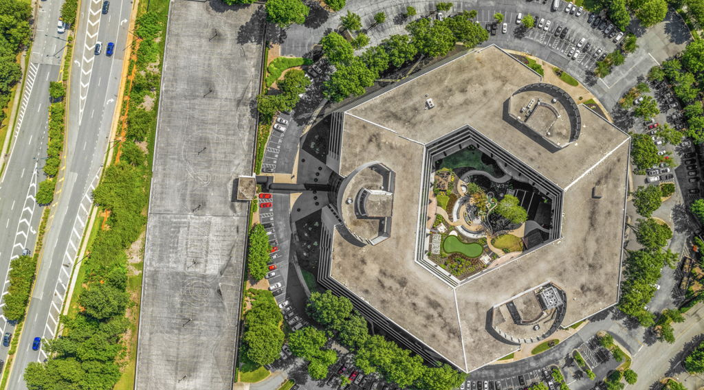 Eagle eye aerial drone photography looking straight down at hexagonal office building with interior courtyard