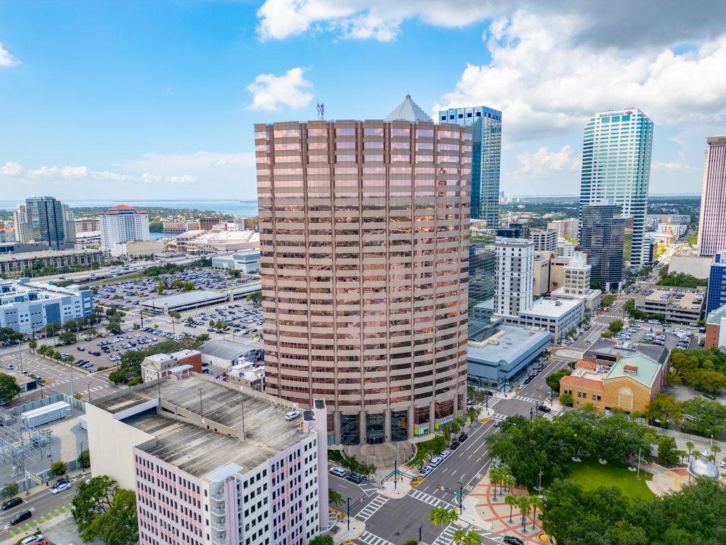 Aerial drone photography of downtown high-rise office tower with bay views and city skyline