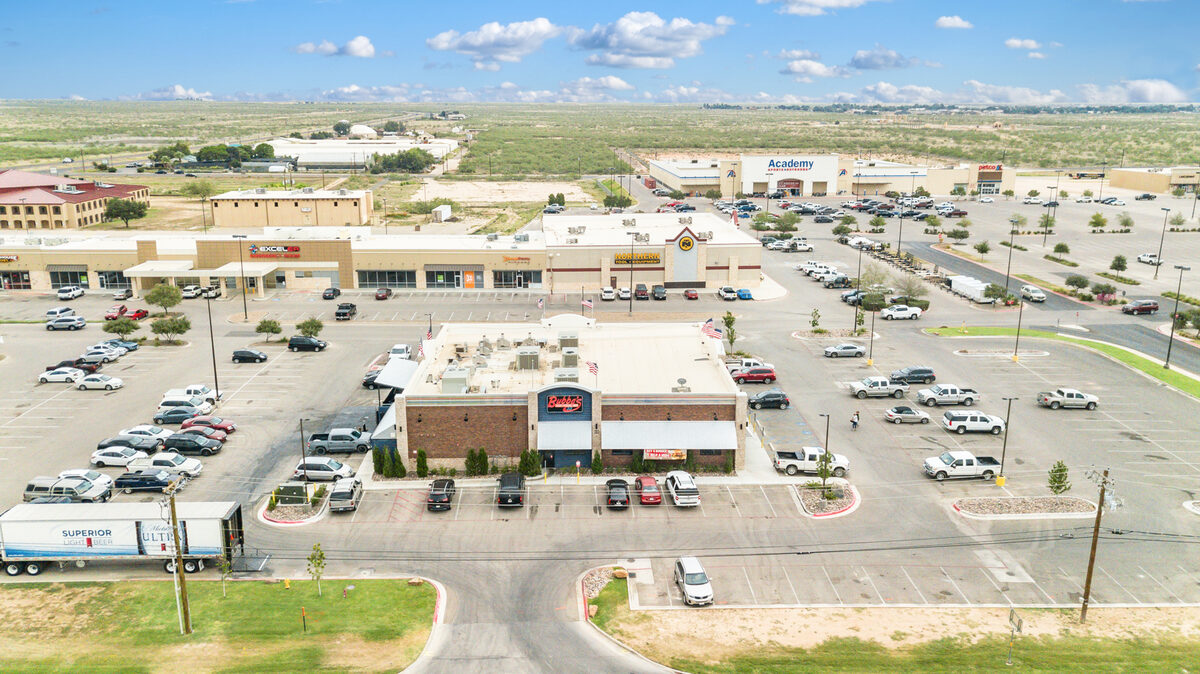 Aerial photography of a retail property at 100ft altitude showing building detail and surrounding businesses