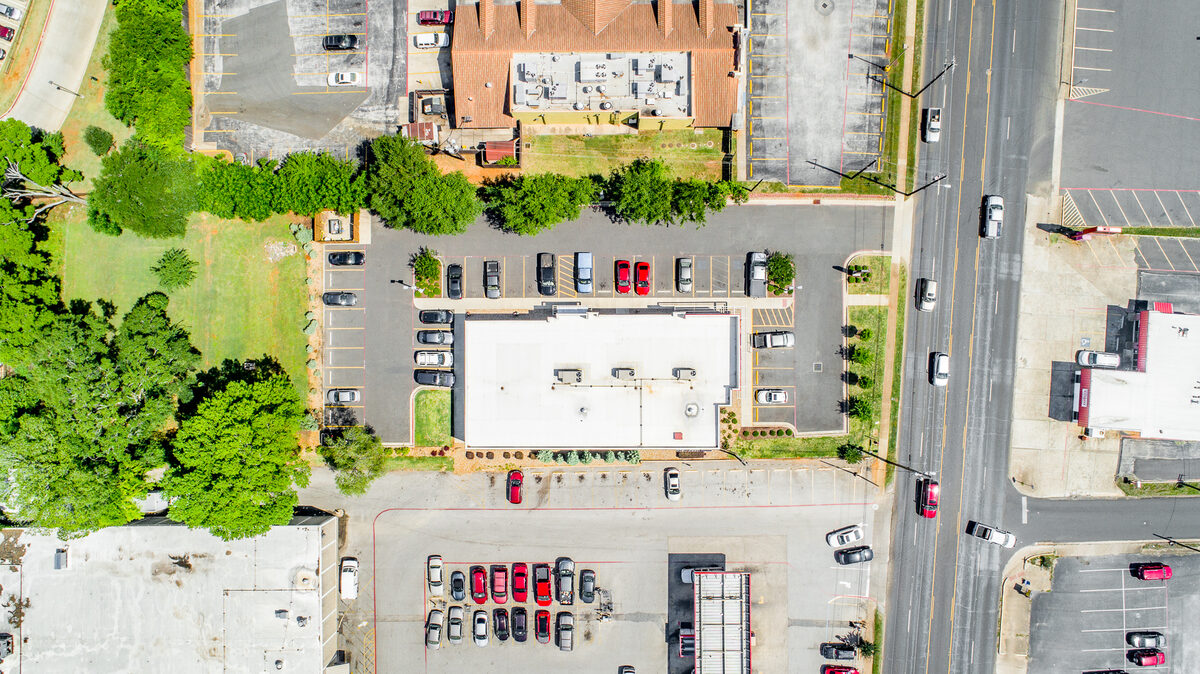 Eagle eye aerial photography showing a straight-down vertical view of a commercial property and parking lot