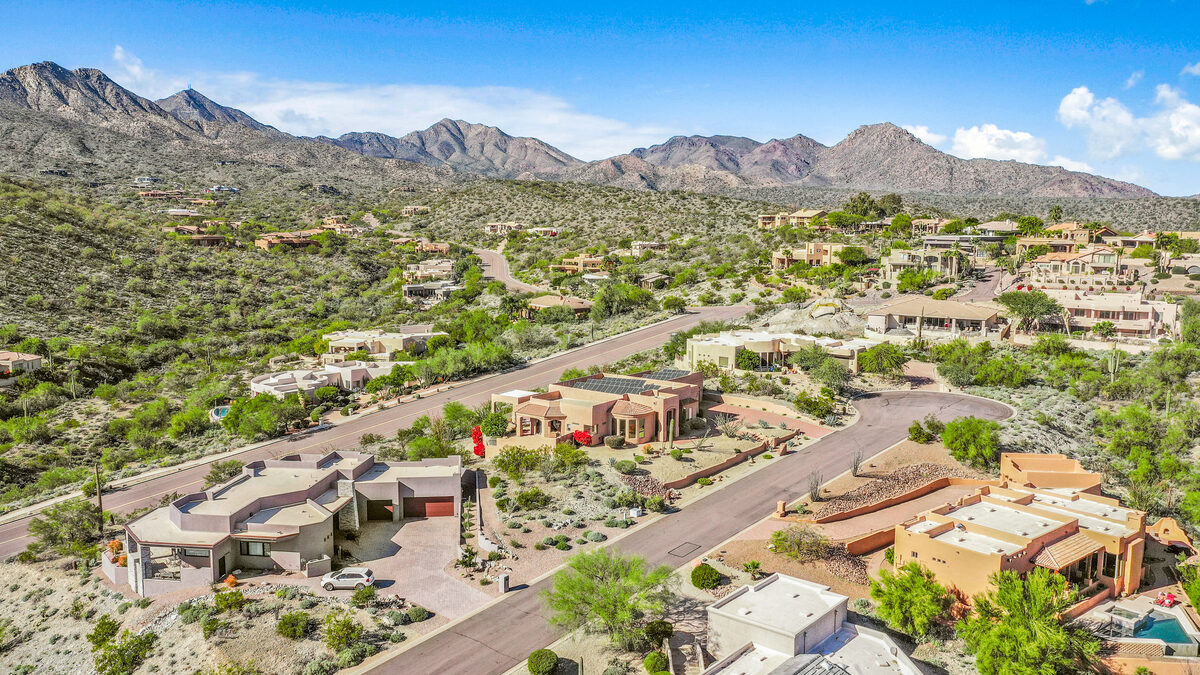 Aerial photography of a residential neighborhood with desert landscape and mountain views