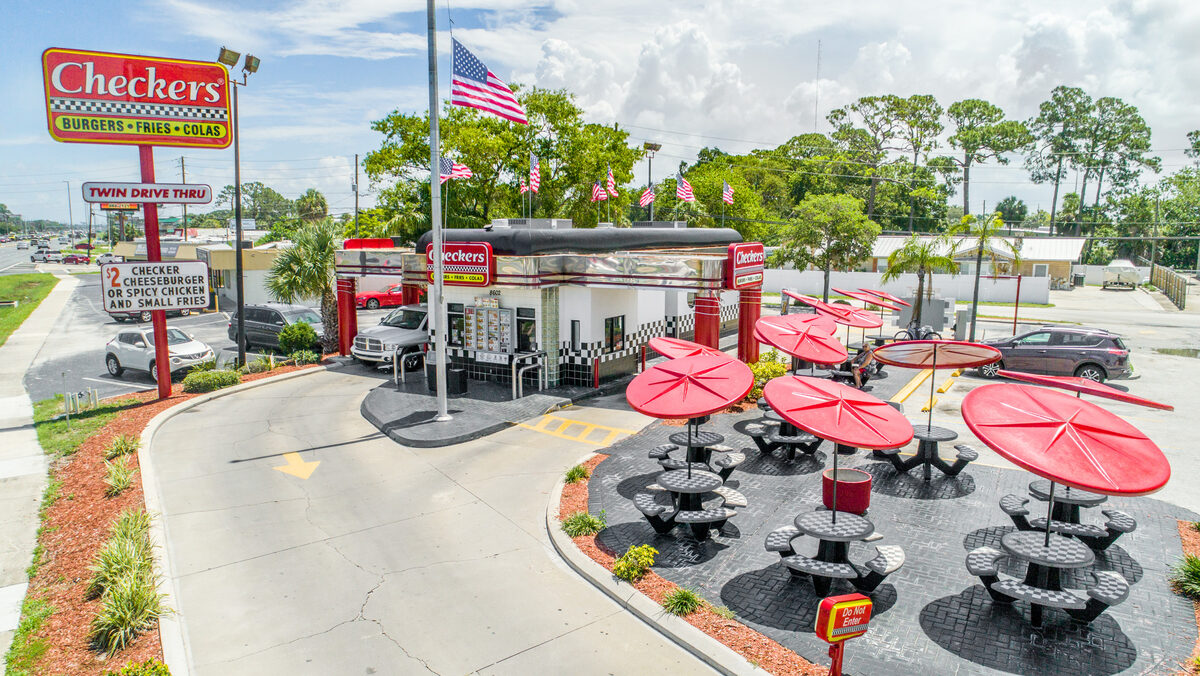 Aerial photography at roof height showing building detail, signage, and surrounding property