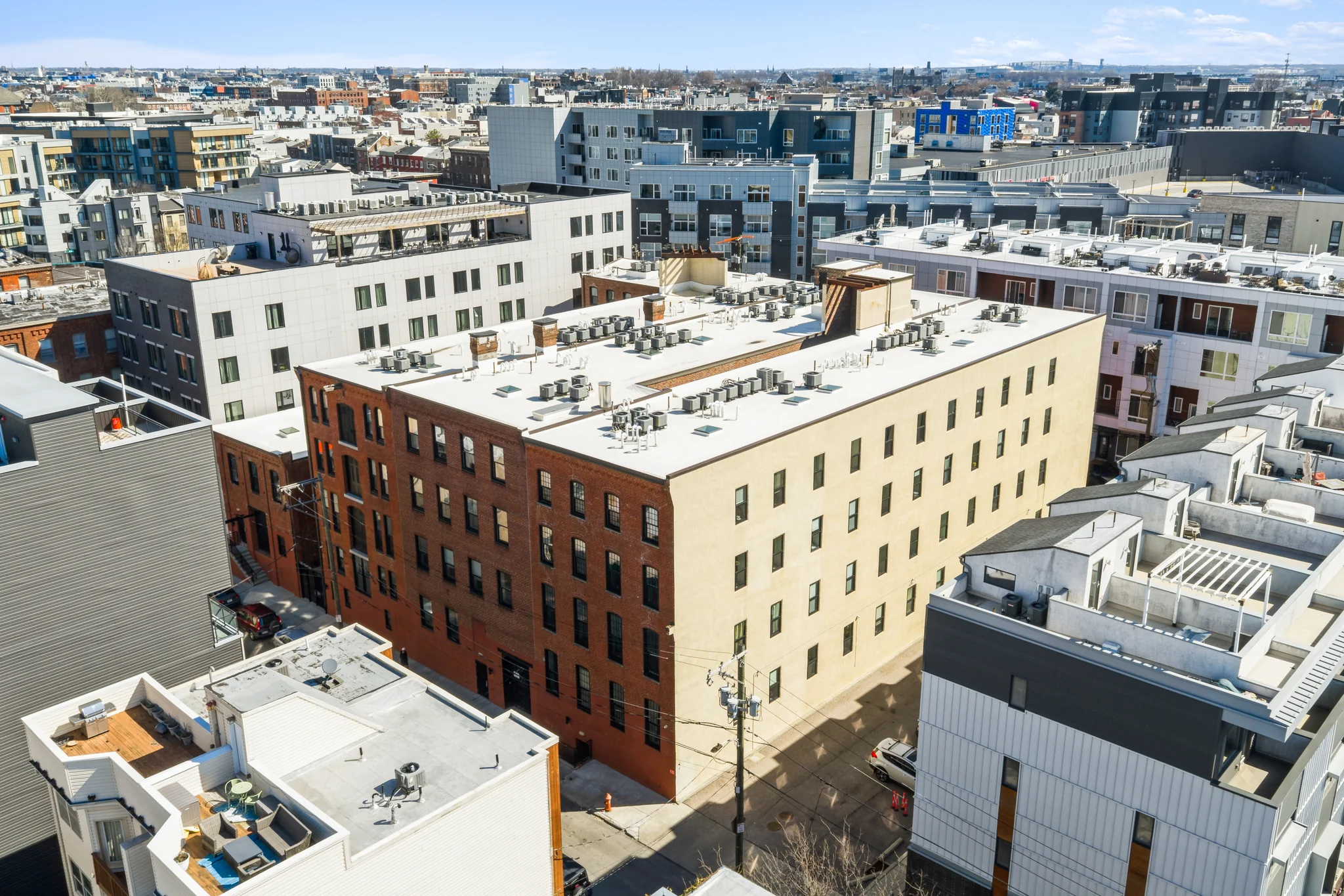 Historic brick warehouse converted to apartments amid modern multi-family infill development