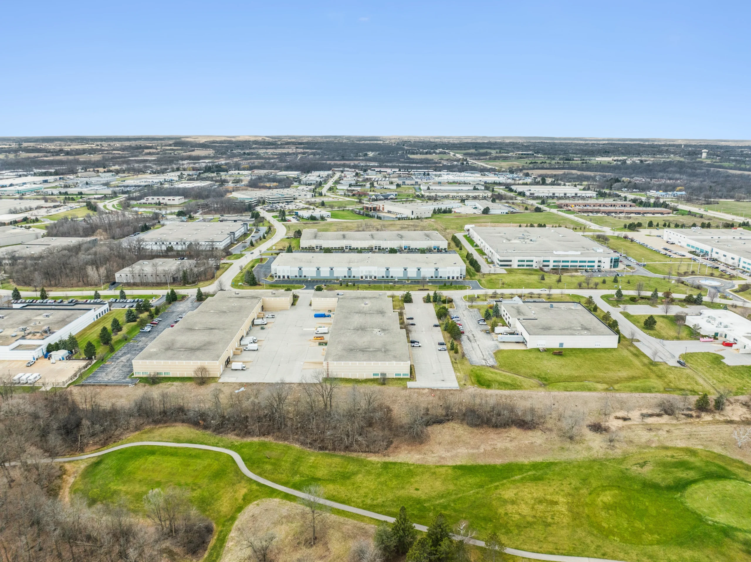 Aerial drone photography of port-adjacent industrial warehouse with waterfront access