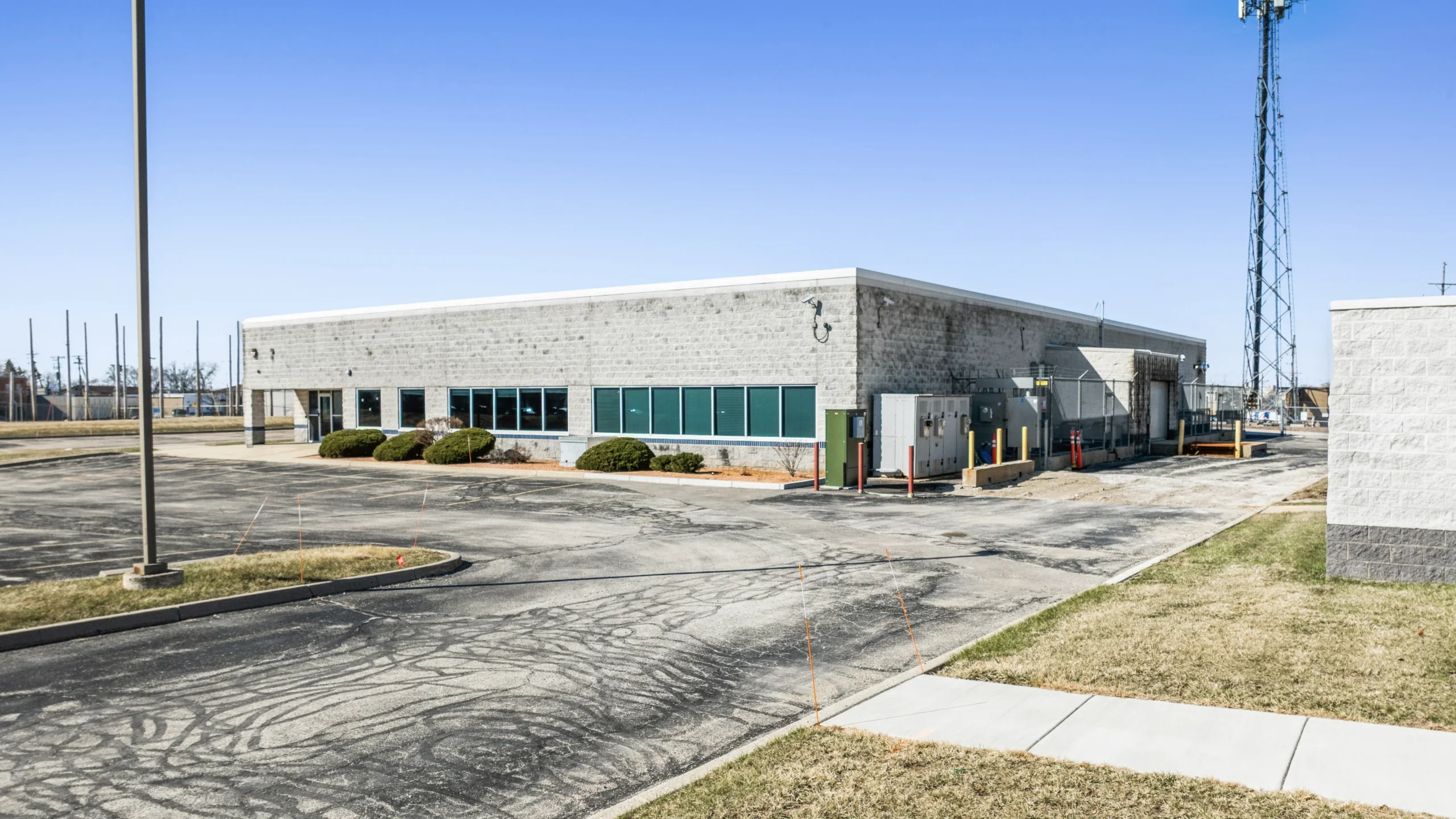 Aerial drone photography of small-bay industrial warehouse with individual tenant entrances