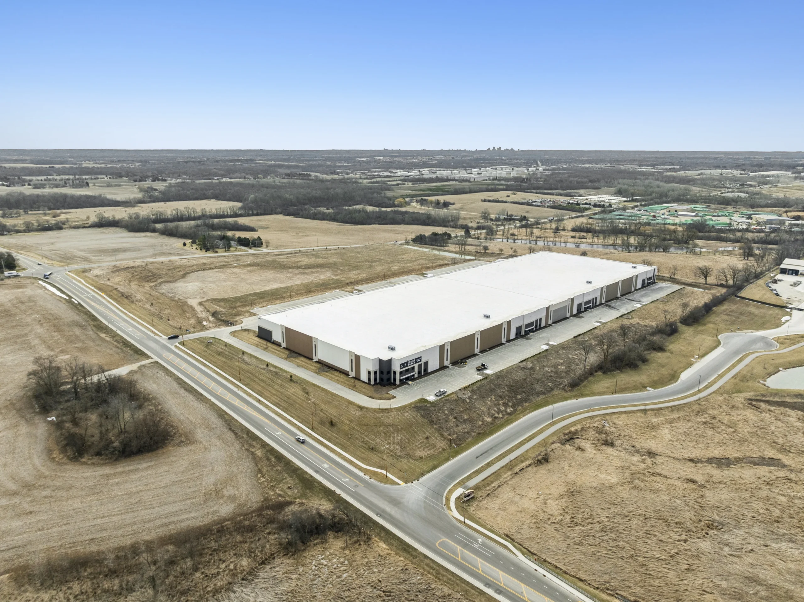 Wide aerial view of large industrial warehouse complex in commercial district