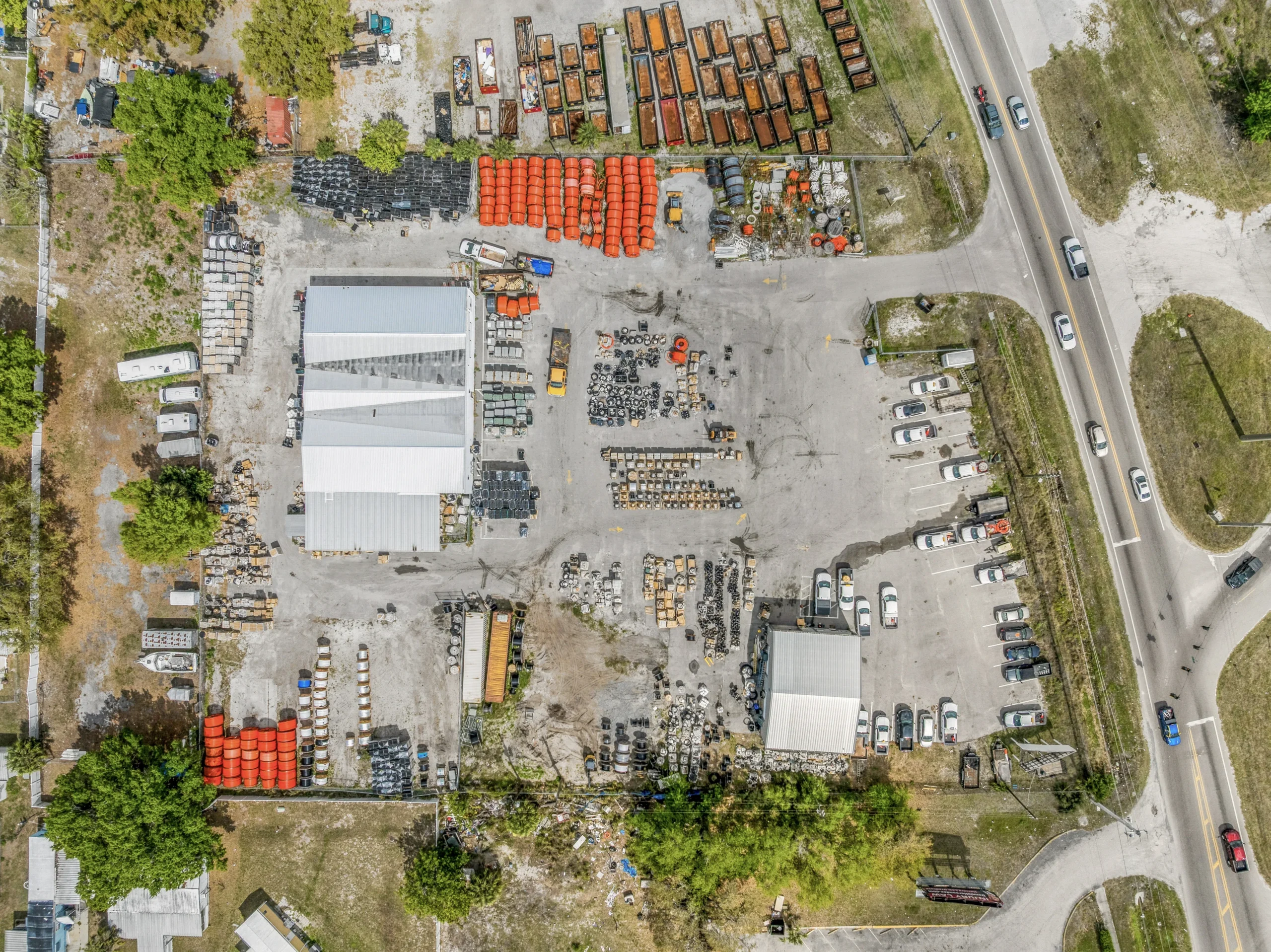 Eagle eye aerial drone photography of industrial yard with equipment and warehouse buildings