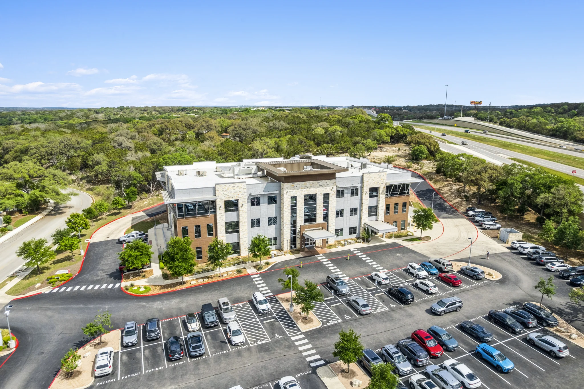 Three-story medical office building with dedicated patient parking and modern stone facade