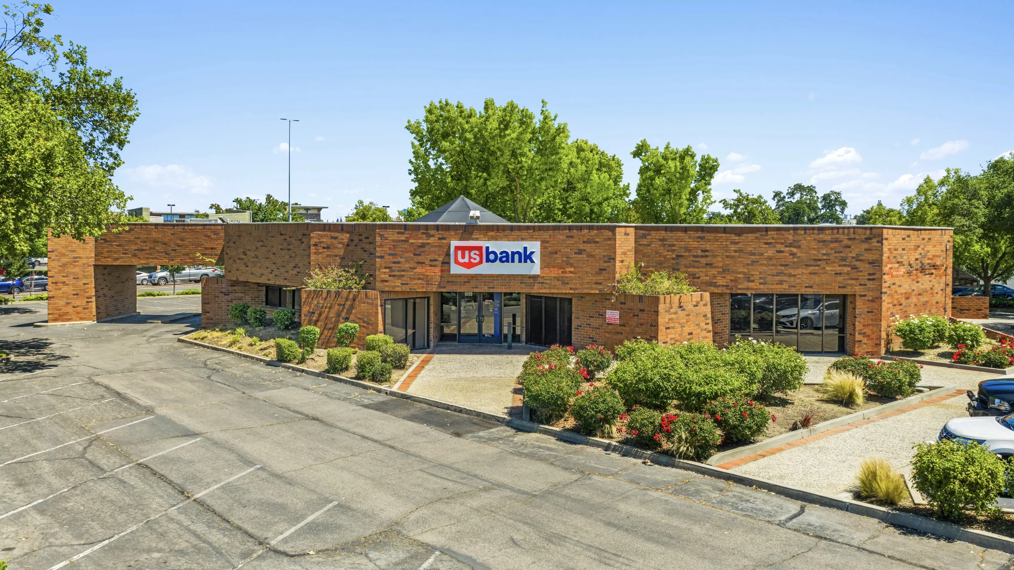 Virtual twilight photograph of a single-tenant Fulton Bank branch with illuminated digital signage and pitched-roof building architecture
