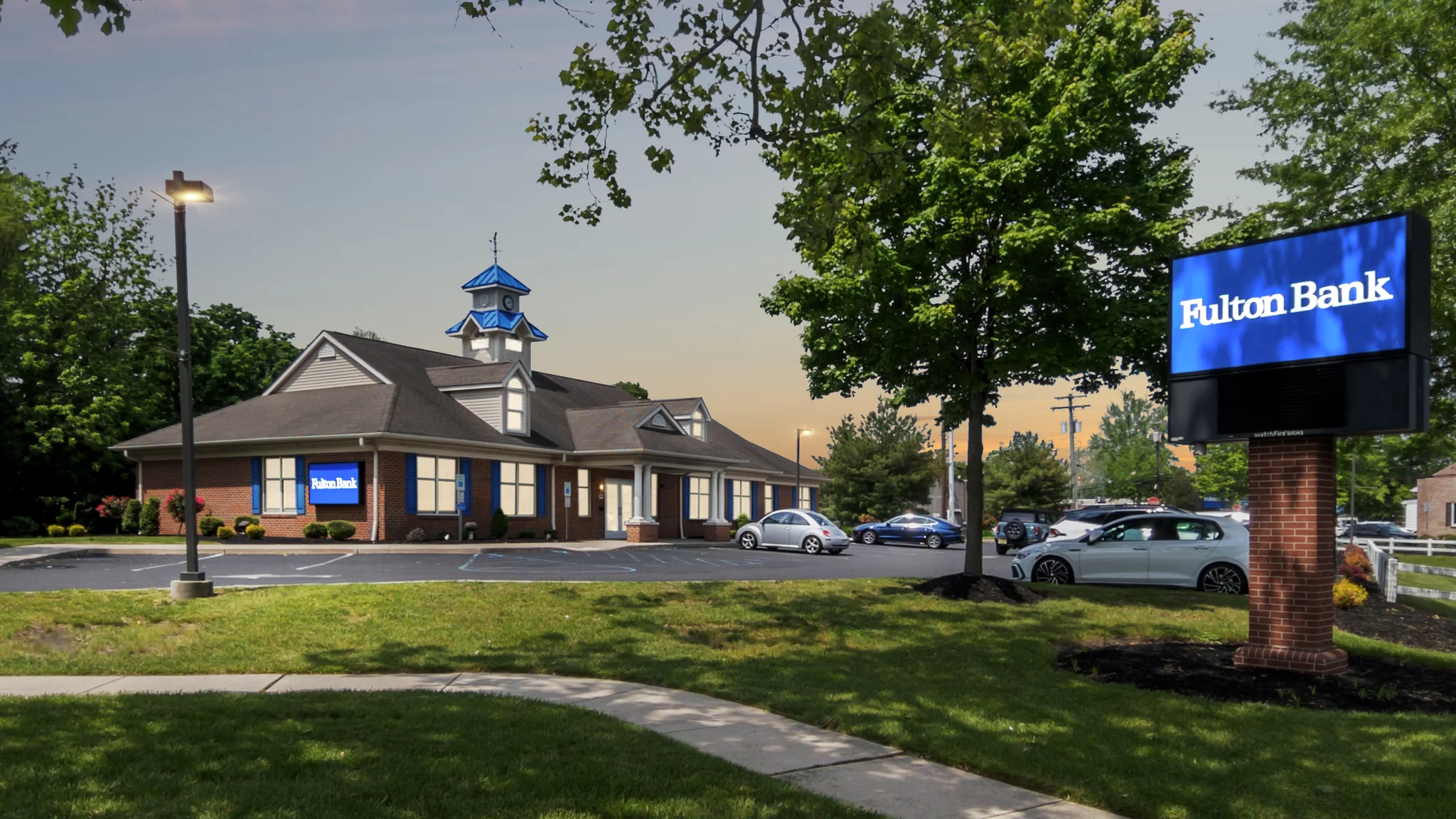 Aerial view of a single-tenant Bank of America branch with corner urban location, pylon signage, and adjacent customer parking