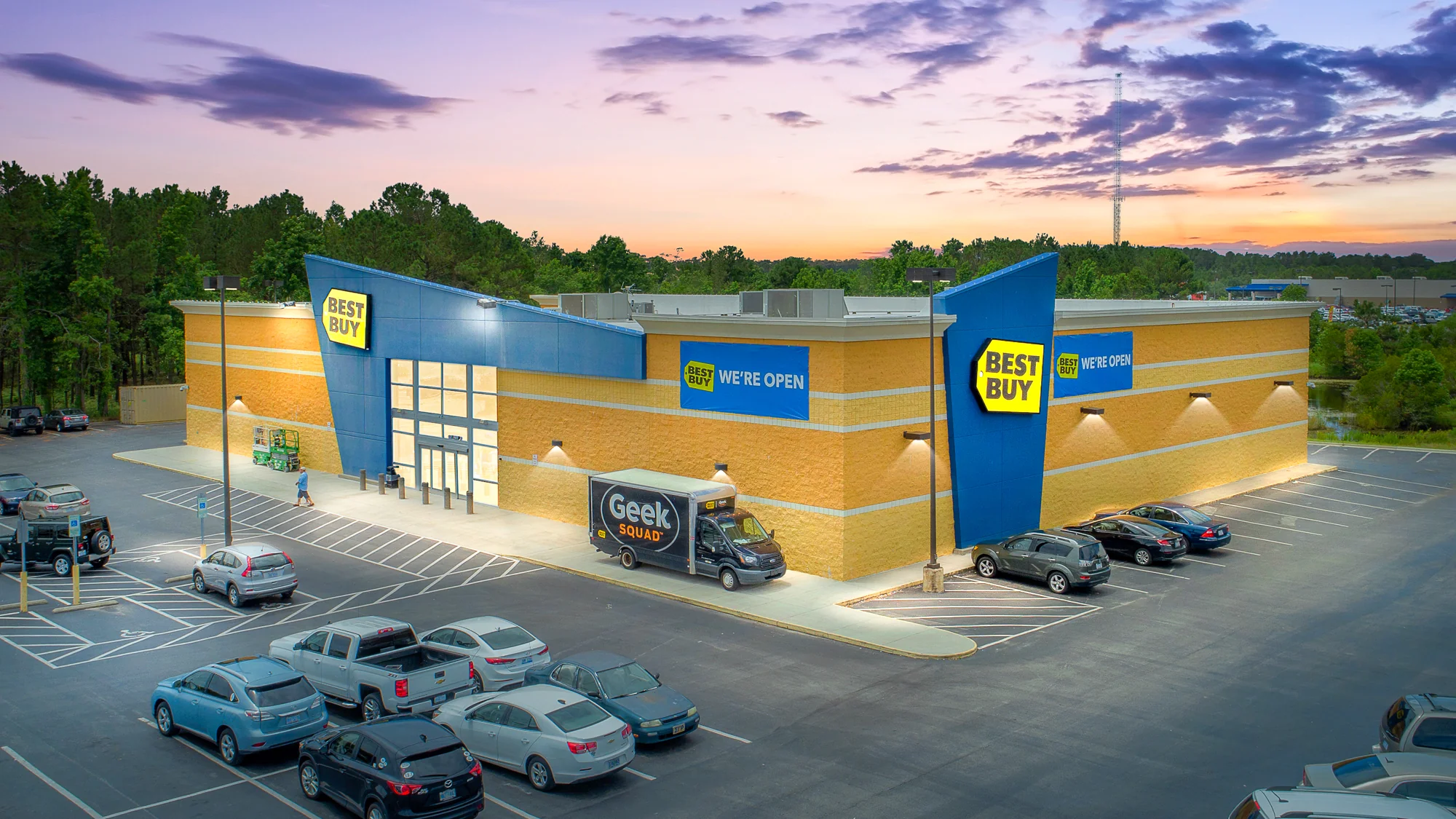 Aerial photograph of a single-tenant Home Depot big-box home improvement store with garden center, large parking field, and surrounding retail corridor